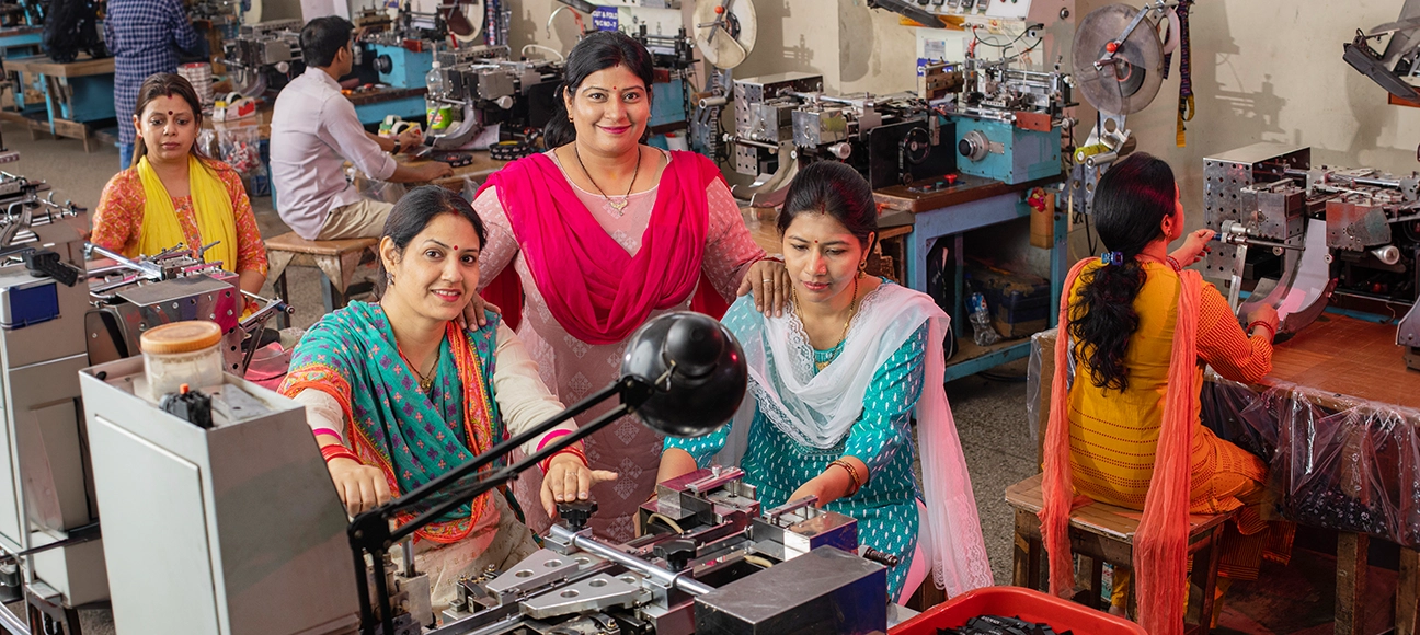Women operating machinery in a small manufacturing unit supported by Northern Arc MSME lending