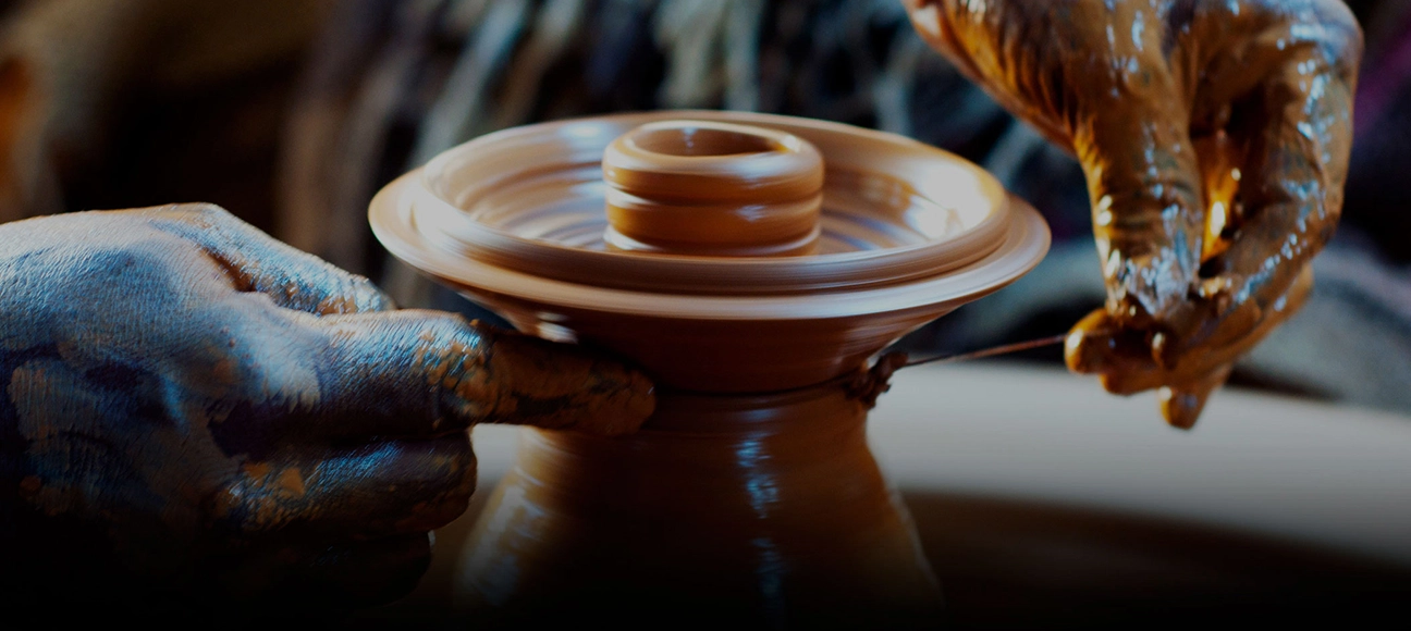 Artisan shaping pottery on a wheel